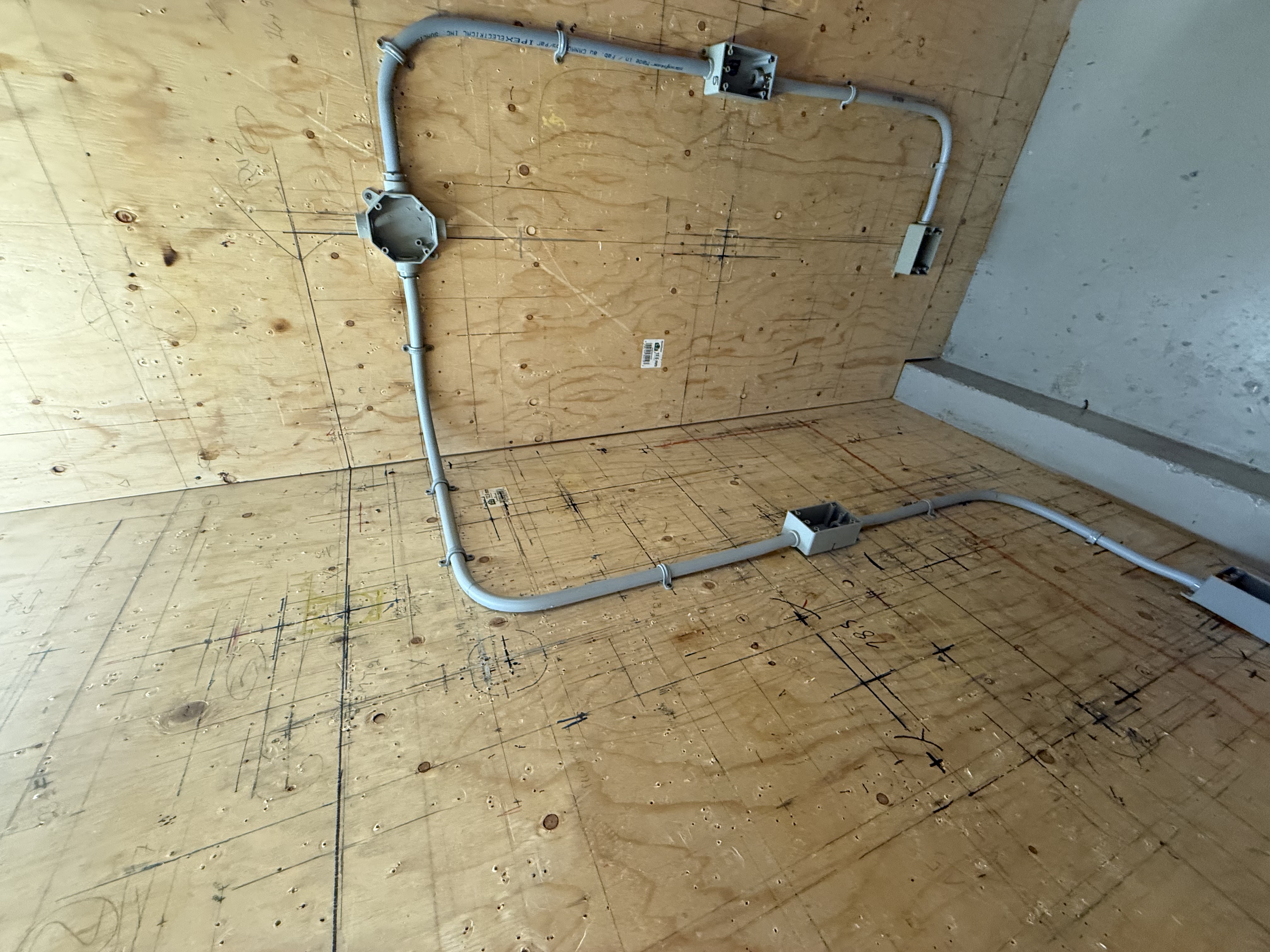 Installation de conduits et de boîtes électriques sur un panneau d’exercice dans le cadre d’une formation DEP en électricité.